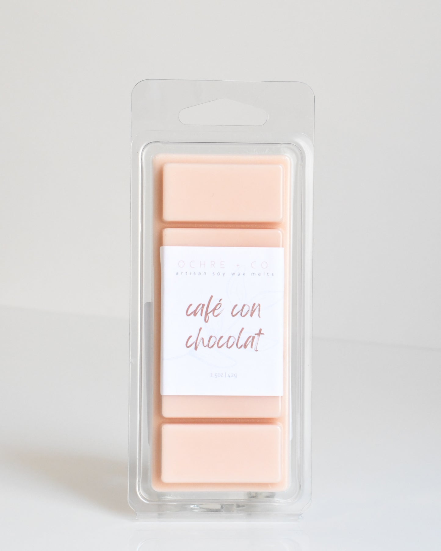 A warm beige wax melt bar called Cafe con Chocolat in its packaging on a white background.