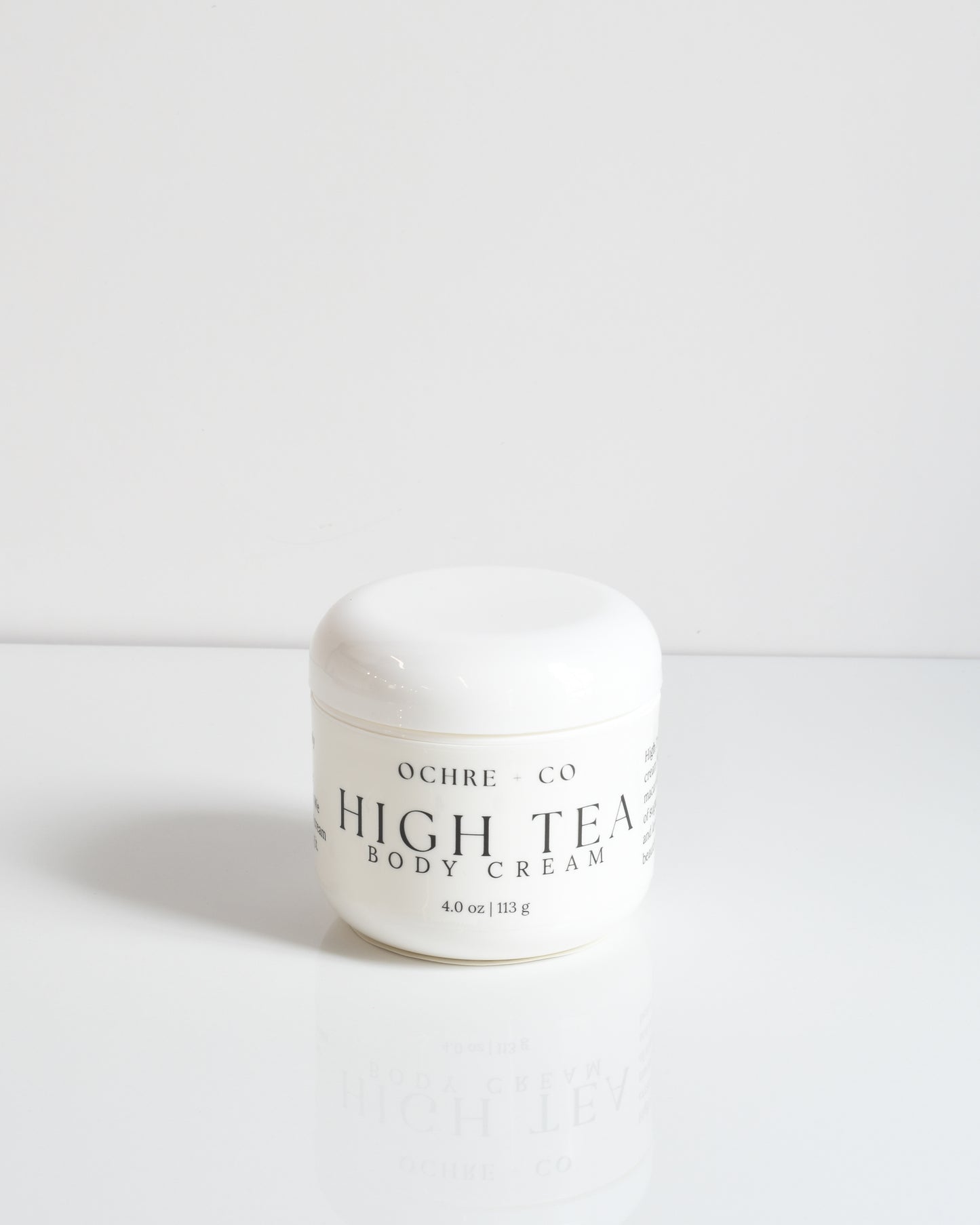 A white jar of High Tea Body Cream by OCHRE on a white background.