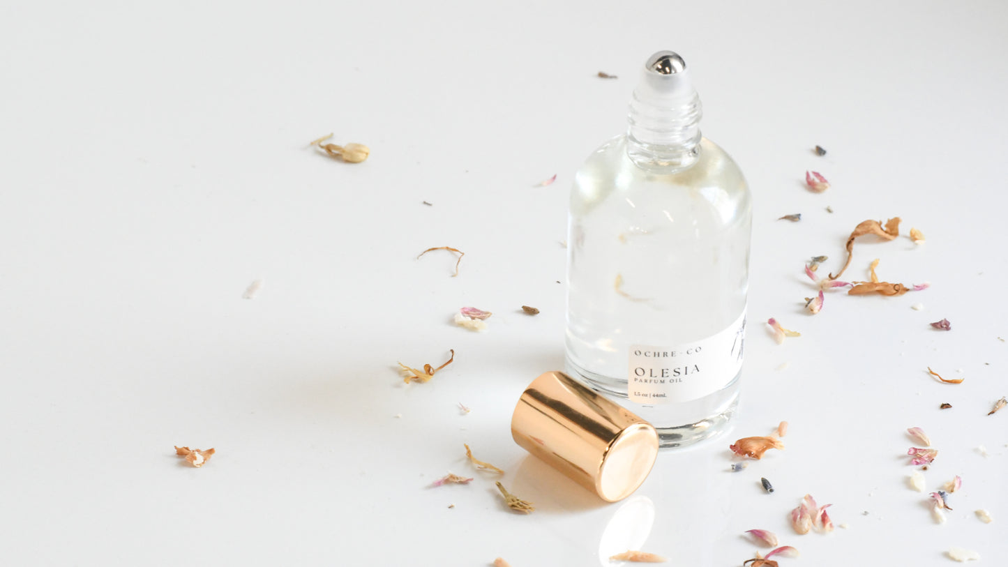 Perfume bottle with gold cap on a light background