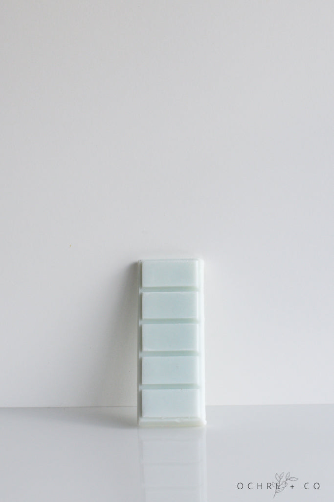 A pale blue-green wax melt snap bar against a white background, branded by OCHRE + CO.