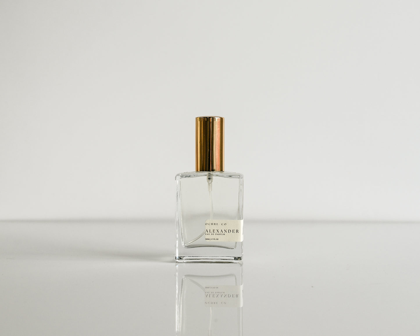 Perfume bottle with gold cap on a white background