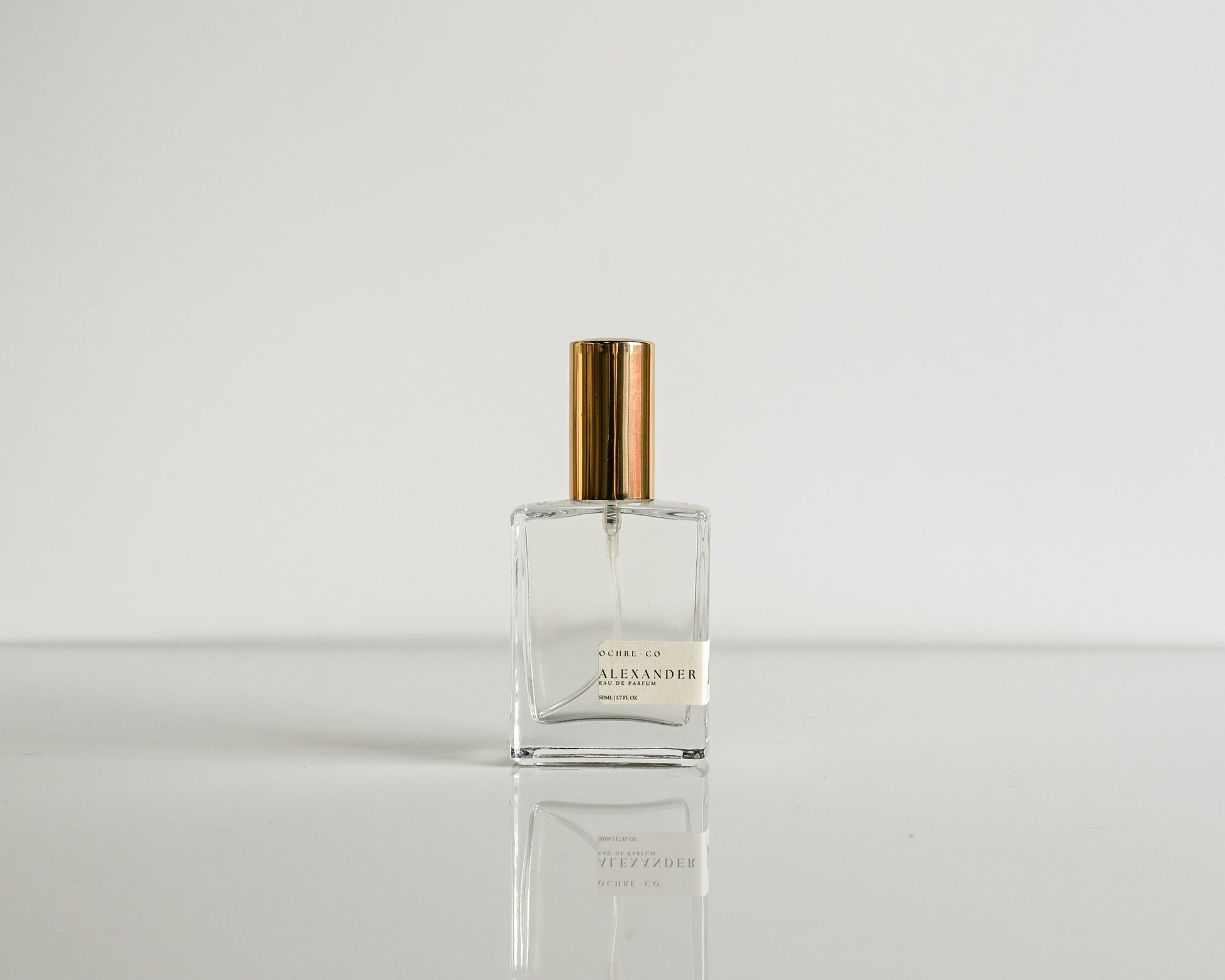 Perfume bottle with gold cap on a white background