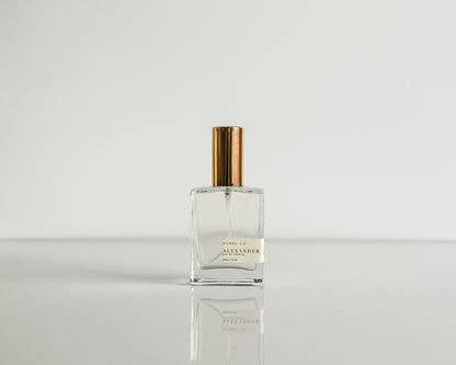 Perfume bottle with gold cap on a white background