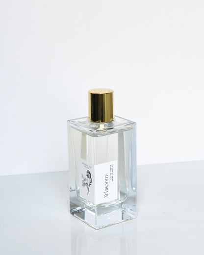A clear glass bottle of 'Aphrodite - Eau de Parfum' with a gold-colored cap, labeled with the product name and brand.
