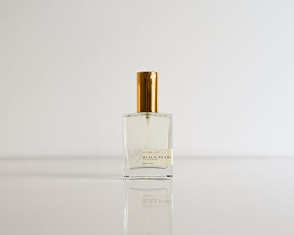 Perfume bottle of Black Pearl on a white reflective surface and white background