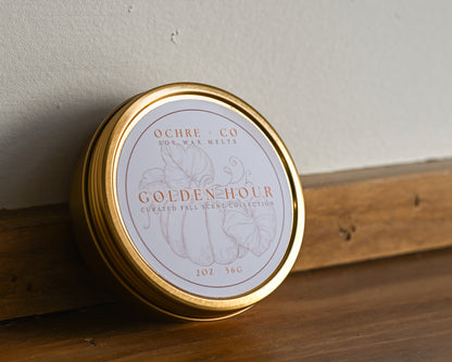 Golden Hour gold tin with label on a wood and white backdrop