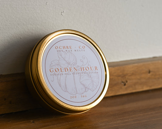Golden Hour gold tin with label on a wood and white backdrop