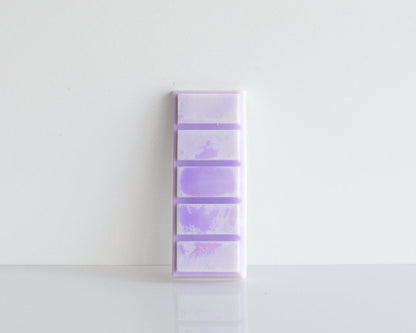 A purple wax melt on a white background
