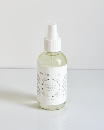 A bottle of Ochre + Co leatherbound room spray with a spray nozzle, labeled as 'LEATHER SOUND' on a white background.