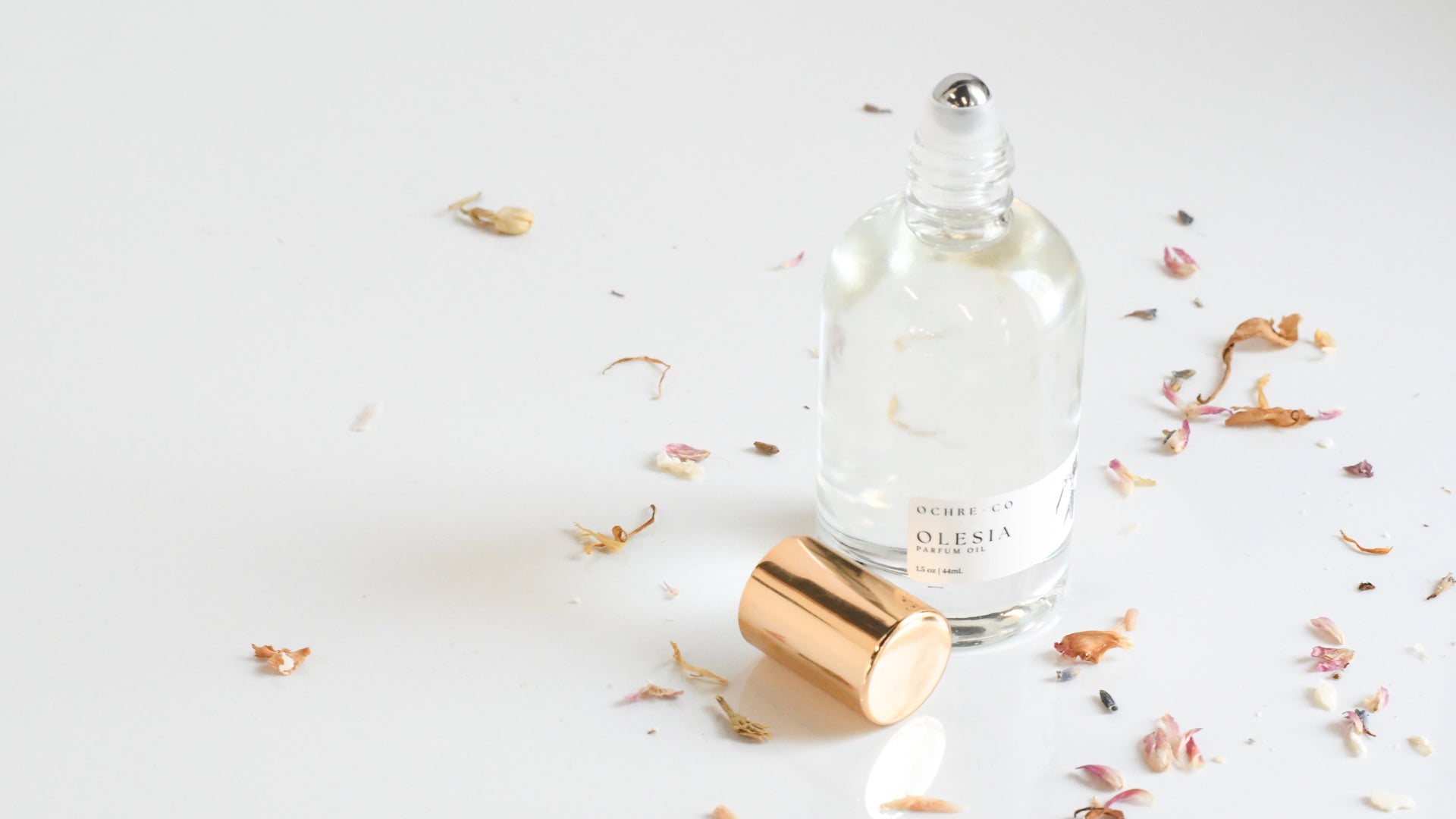 Perfume bottle with gold cap on a light background