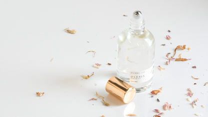 Perfume bottle with gold cap on a light background
