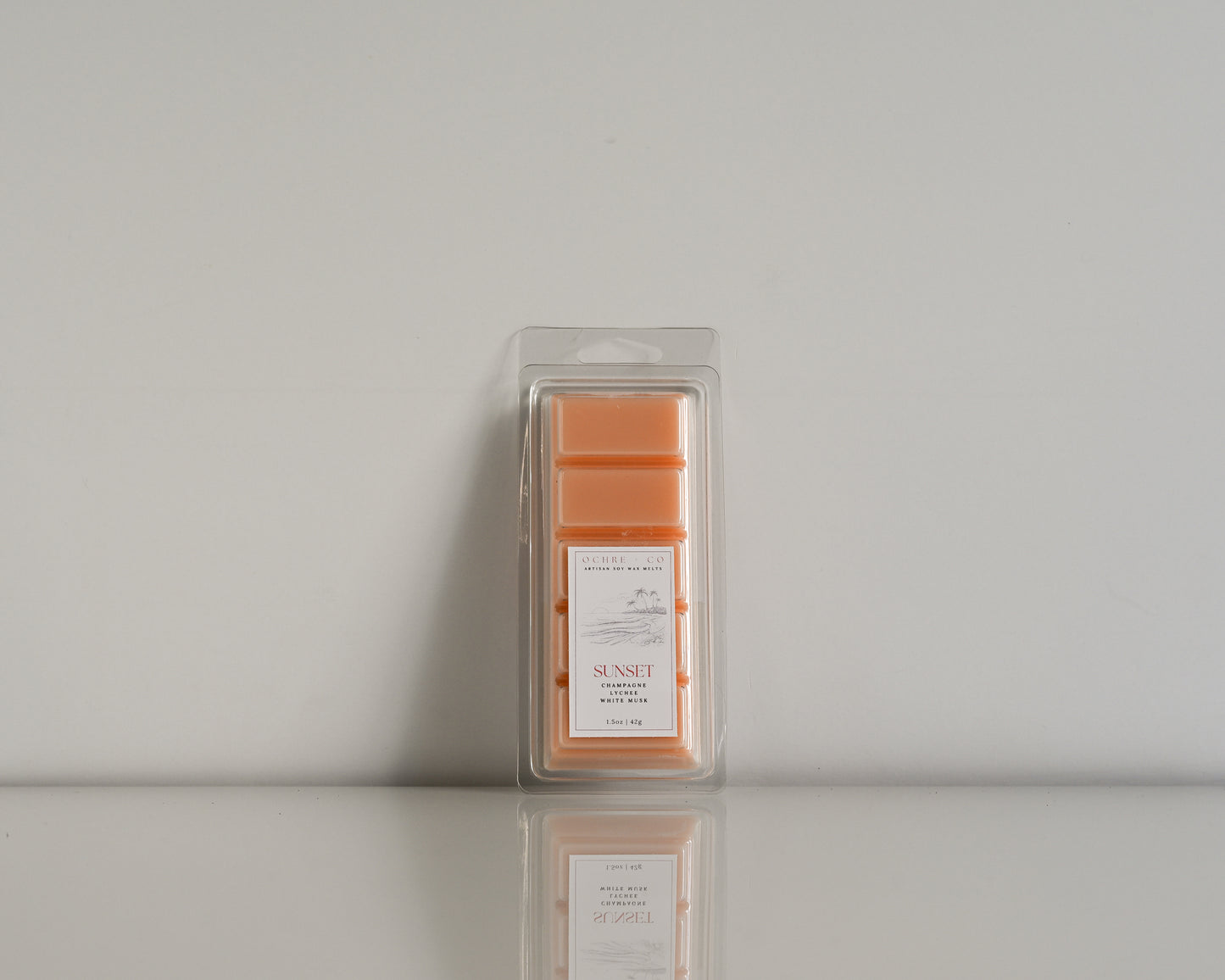Packaged wax melt labeled 'Sunset' on a soft white background