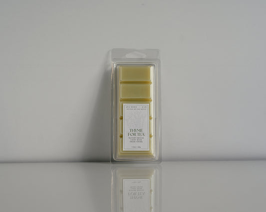 Thyme for Tea wax melt on a white background and reflective surface