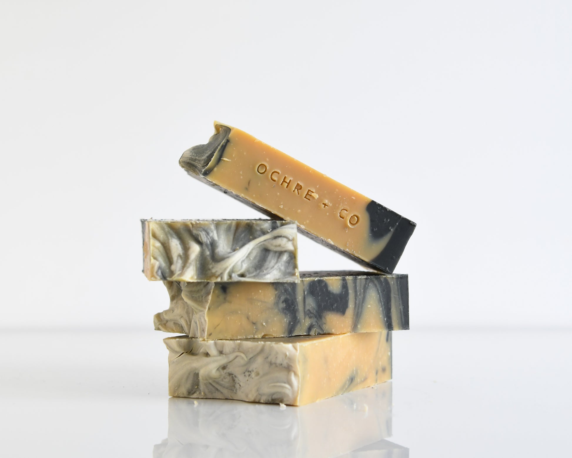 Marbled soap bars with 'Ochre & Co' branding on a white background