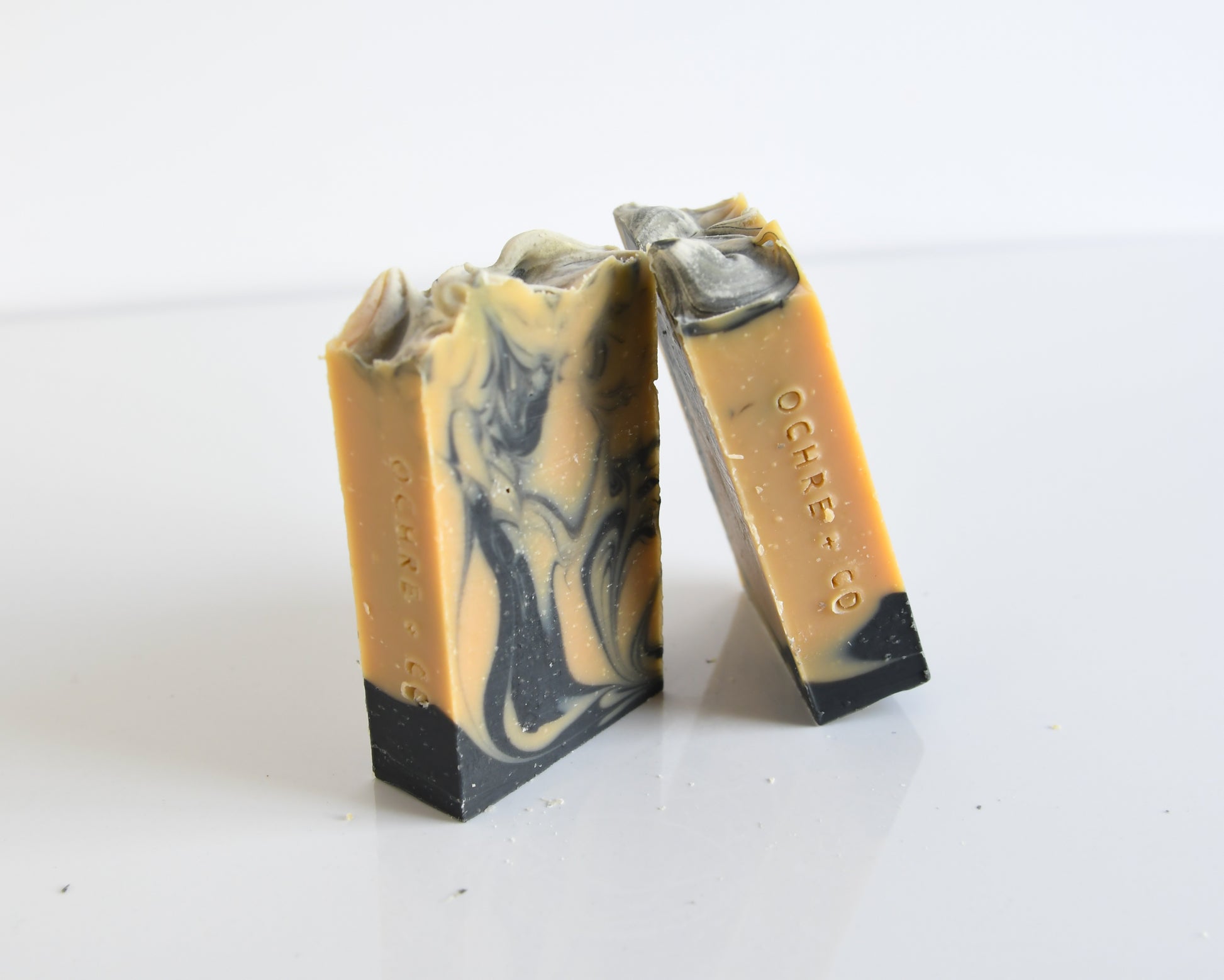 Two bars of soap with a marbled pattern on a white background