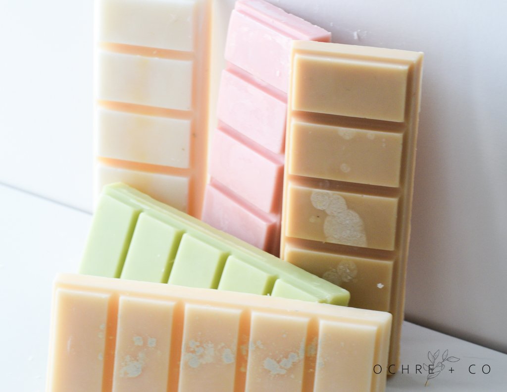 Handmade wax melts from OCHRE + CO with a striped pattern on a white background