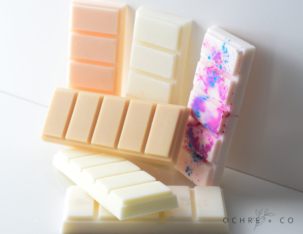 Collection of wax melts on a white background, featuring the brand 'Ochre & Co'.