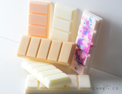 Collection of wax melts on a white background, featuring the brand 'Ochre & Co'.